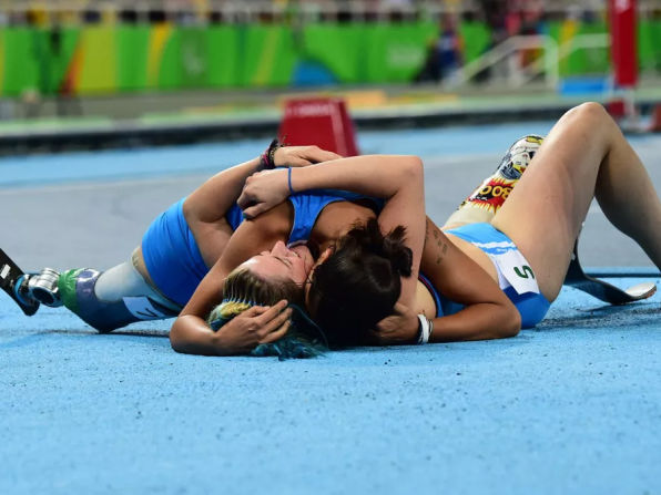 Gold medalist Martina Caironi of Italy and bronze medalist Monica Graziana Contrafatto of Italy celebrate on the track after completing the Women's 100m - T42 Final during Day 10 of the Rio 2016 Paralympic Games at the Olympic Stadium on September 17, 2016 in Rio de Janeiro, Brazil